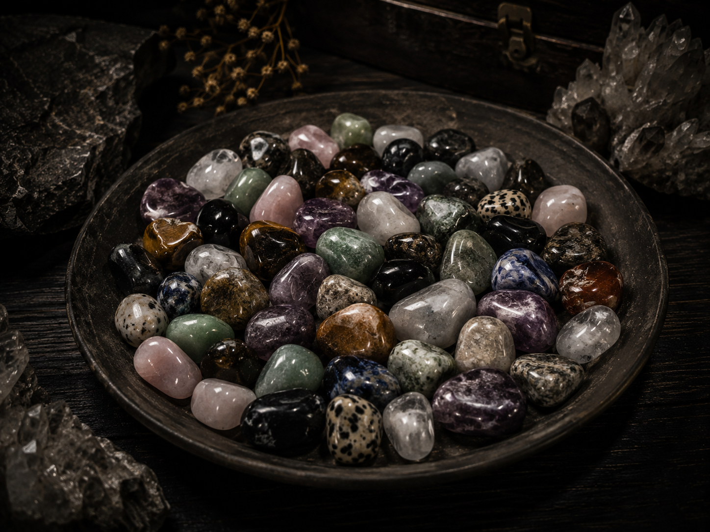 Collection of polished crystals and tumbled stones including amethyst, rose quartz, labradorite, tiger eye and snowflake obsidian